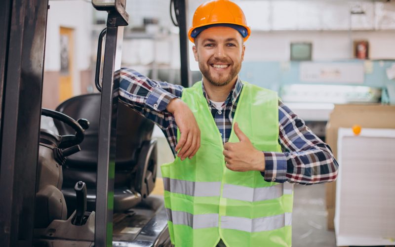 Man working at warehouse and driving forklift